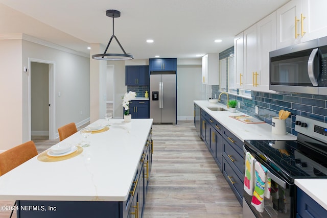 kitchen with a sink, white cabinetry, blue cabinets, a center island, and stainless steel appliances