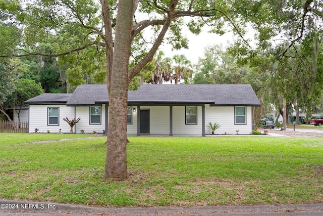 ranch-style house with a front lawn and roof with shingles