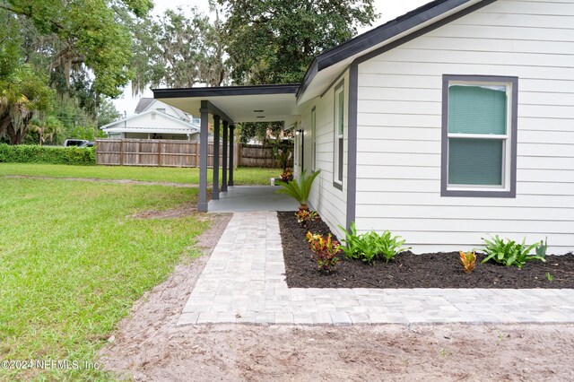 view of side of home featuring a yard