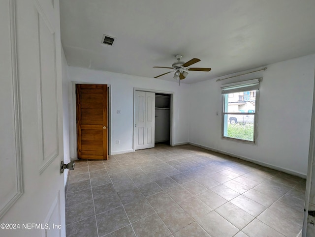 unfurnished bedroom featuring light tile patterned floors and ceiling fan