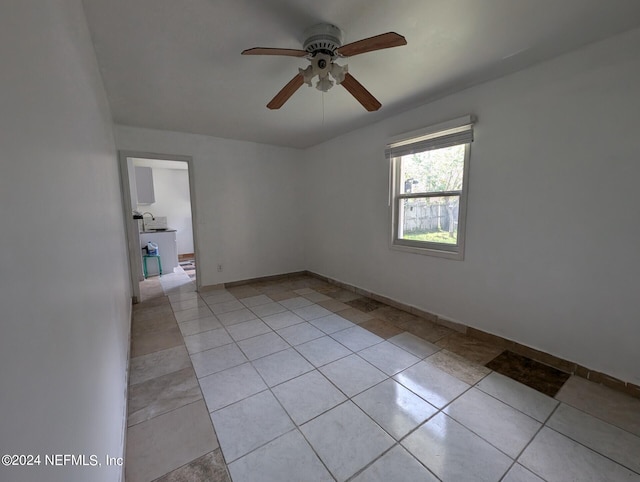 unfurnished room with light tile patterned floors and ceiling fan