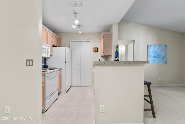 kitchen featuring light brown cabinets, lofted ceiling, kitchen peninsula, white appliances, and a kitchen bar