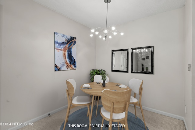 dining room featuring carpet floors and an inviting chandelier