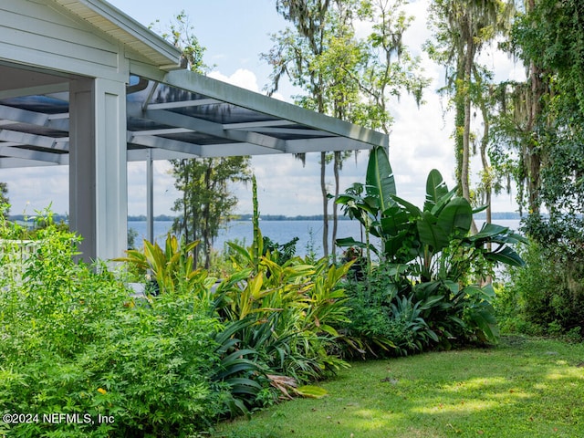 view of yard featuring a water view and a pergola