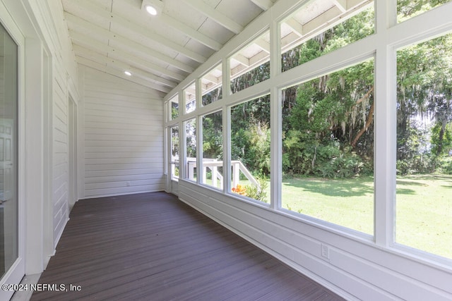 unfurnished sunroom featuring vaulted ceiling and a healthy amount of sunlight