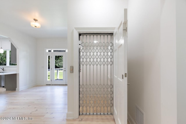 foyer with a wealth of natural light and light hardwood / wood-style floors