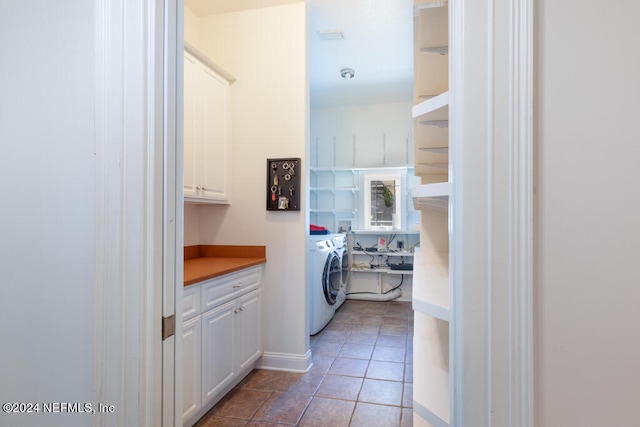 laundry room with washer / clothes dryer, cabinets, and tile patterned floors