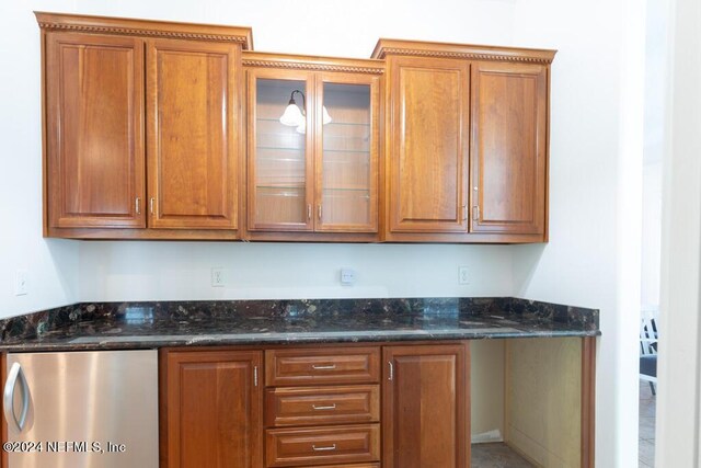 kitchen with dark stone countertops and dishwasher