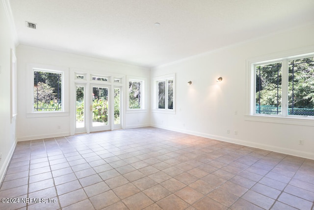 unfurnished room featuring light tile patterned flooring and ornamental molding