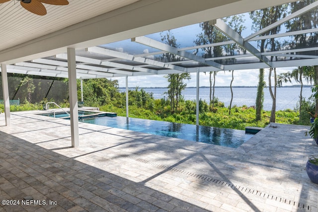 view of pool with a patio, a water view, and ceiling fan