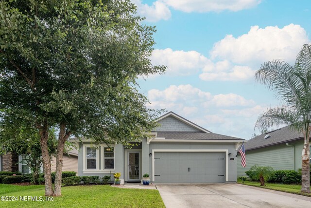 view of front facade with a garage and a front lawn