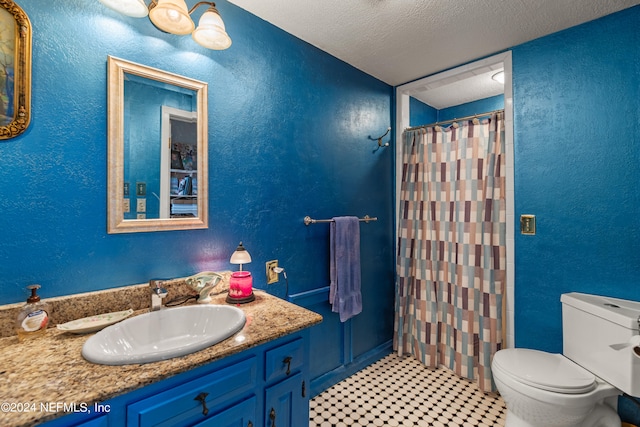 bathroom featuring tile patterned flooring, a textured ceiling, a shower with curtain, vanity, and toilet