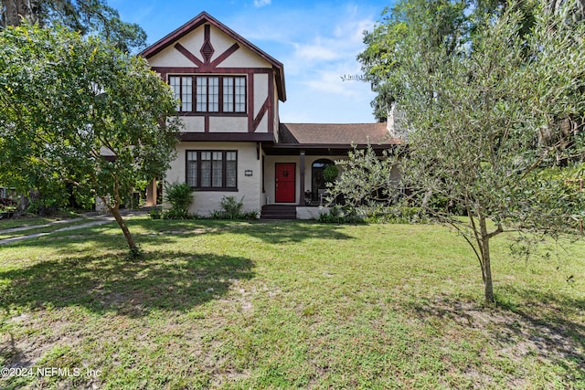 tudor home featuring a front yard