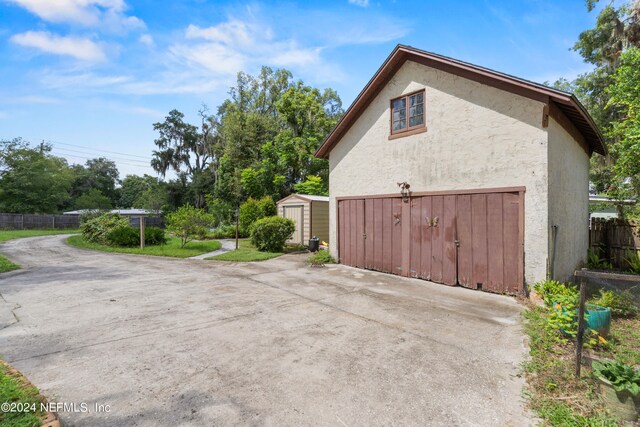 view of home's exterior with a storage unit