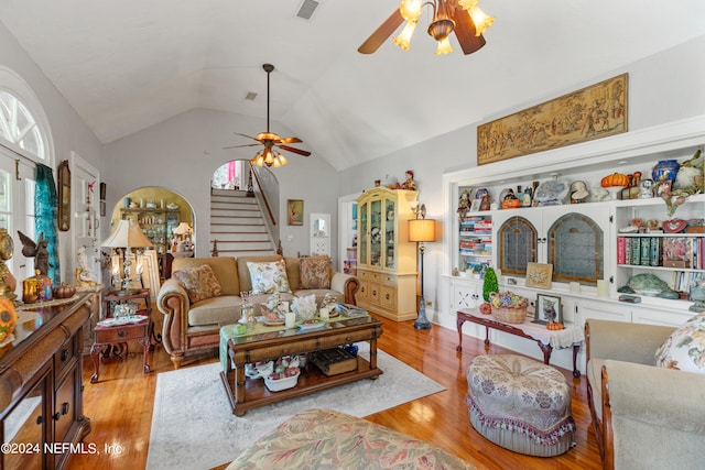 living room featuring vaulted ceiling, ceiling fan, and light hardwood / wood-style flooring