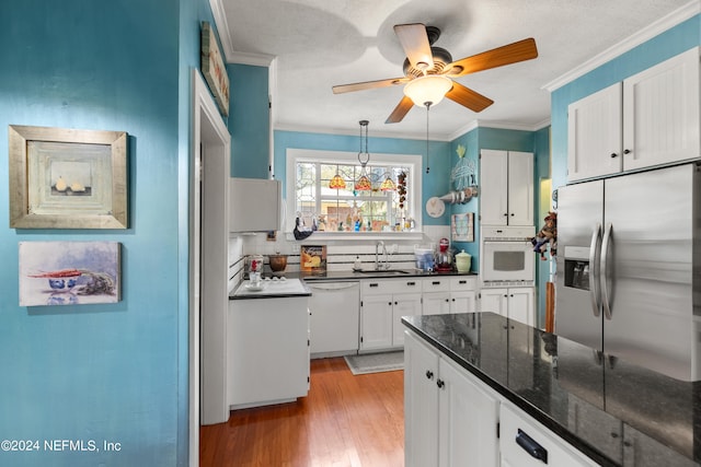 kitchen featuring ceiling fan, light wood-type flooring, white appliances, and white cabinetry