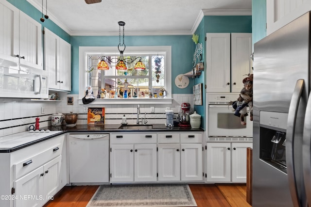 kitchen featuring white appliances, sink, dark hardwood / wood-style flooring, and white cabinets