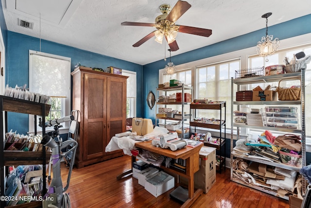 home office with ceiling fan, a textured ceiling, and dark hardwood / wood-style floors