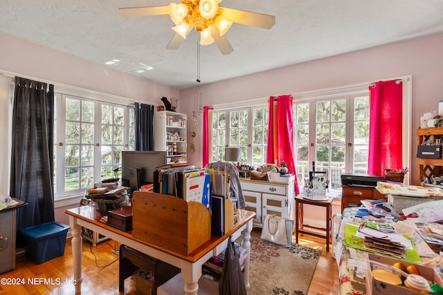 office featuring light wood-type flooring, ceiling fan, and plenty of natural light