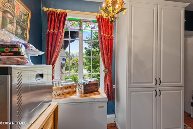 kitchen featuring white cabinets, hardwood / wood-style flooring, and a healthy amount of sunlight