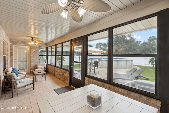 sunroom featuring ceiling fan