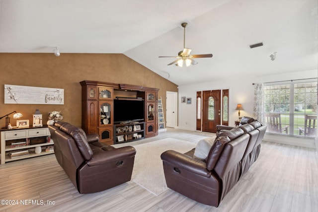 living room featuring vaulted ceiling, ceiling fan, and light hardwood / wood-style flooring