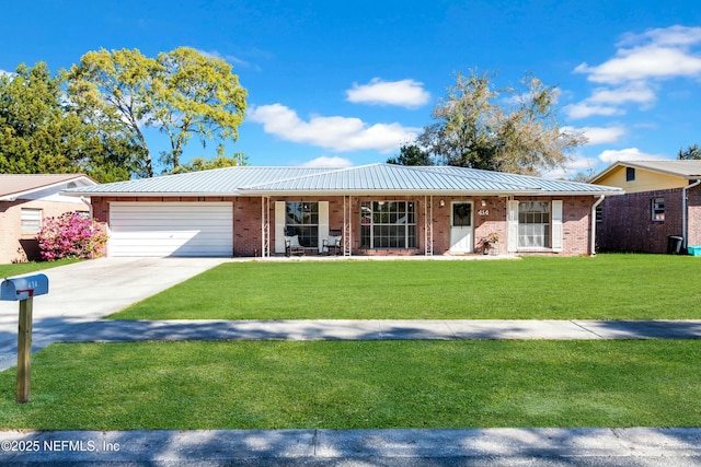 single story home with a front lawn, driveway, covered porch, a garage, and brick siding