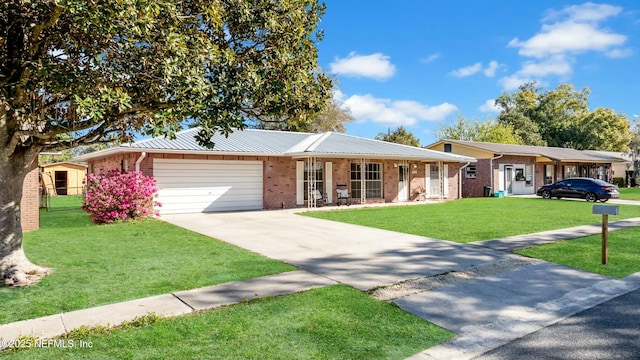 ranch-style home featuring a front lawn, an attached garage, brick siding, and driveway