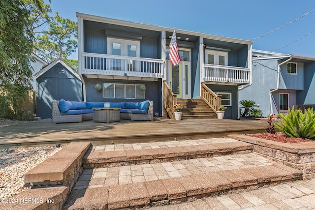 view of front of home featuring a deck, a balcony, and an outdoor hangout area