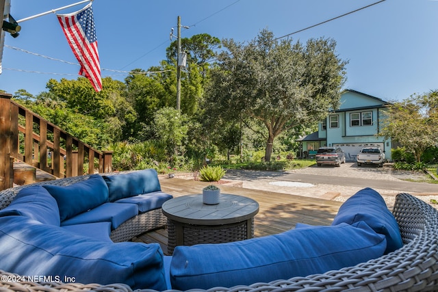 view of patio / terrace with an outdoor hangout area, a deck, and a garage