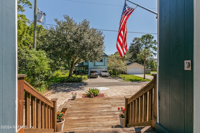 wooden deck featuring a garage