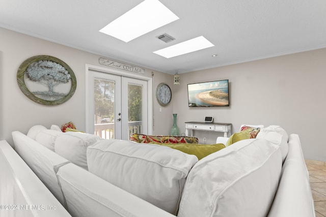 tiled living room featuring a skylight and french doors