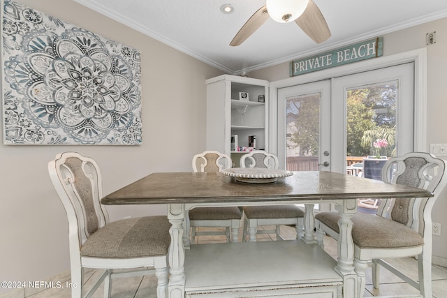 dining space featuring french doors, light tile patterned flooring, ornamental molding, and ceiling fan