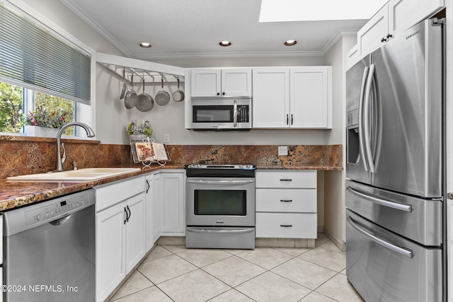 kitchen with ornamental molding, stainless steel appliances, sink, and white cabinetry