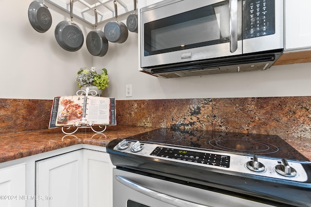 kitchen featuring appliances with stainless steel finishes and white cabinets