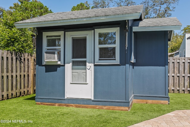 view of outbuilding featuring a lawn