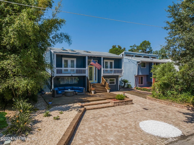 view of front of home featuring a patio area and an outdoor hangout area