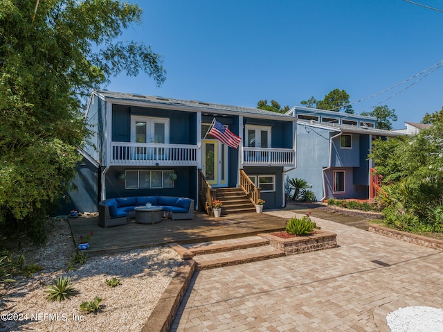 view of front of property with a patio and an outdoor living space