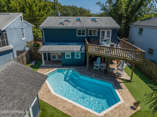 back of property with a patio and a pool side deck