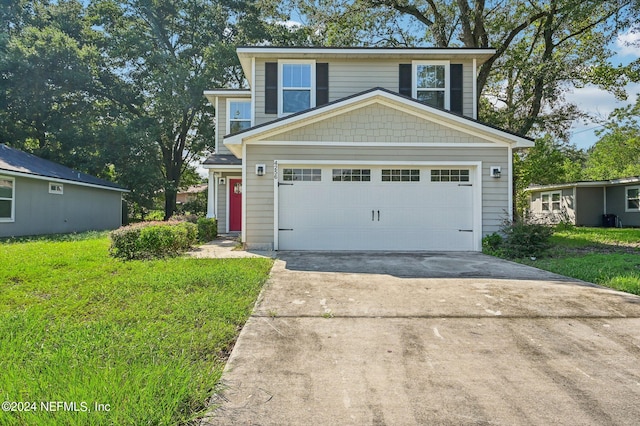 front facade featuring a front lawn and a garage