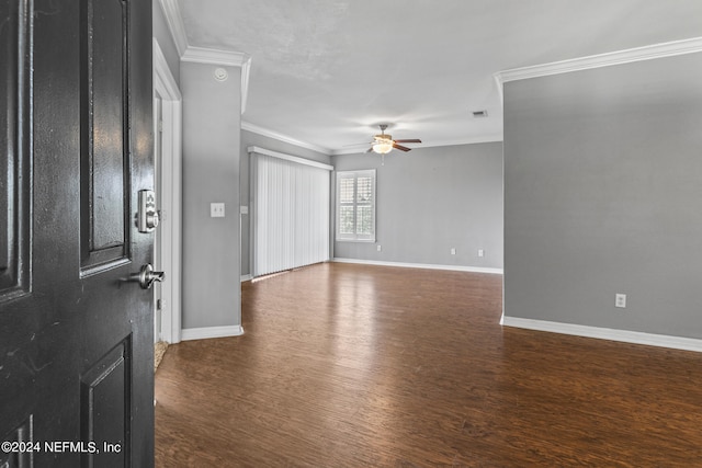 unfurnished room featuring ceiling fan, crown molding, and dark wood-type flooring