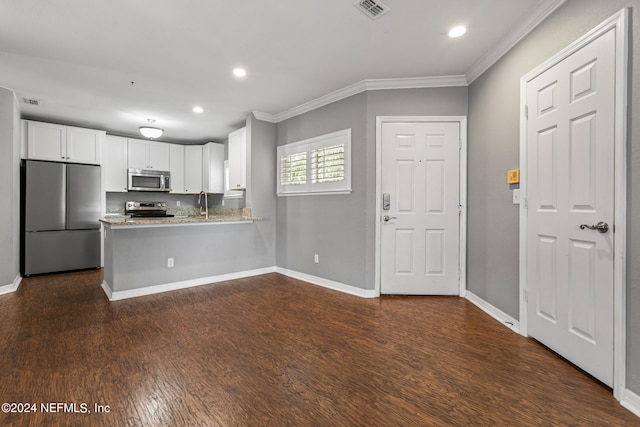 kitchen featuring kitchen peninsula, dark hardwood / wood-style flooring, stainless steel appliances, and white cabinets