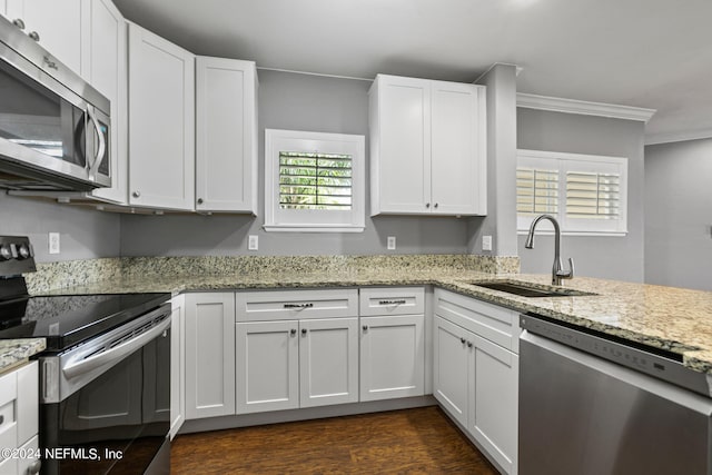 kitchen with white cabinets, appliances with stainless steel finishes, sink, and a wealth of natural light