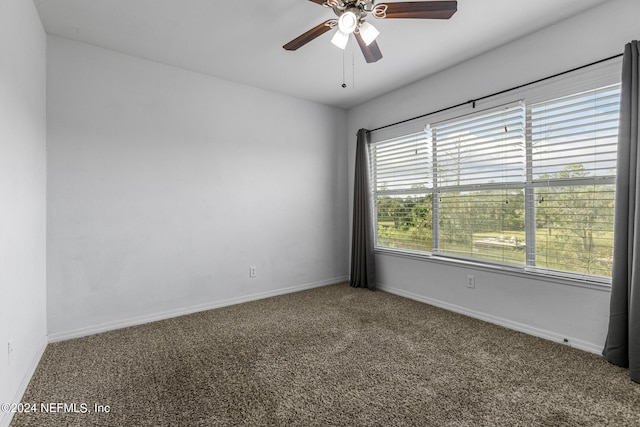 carpeted empty room featuring ceiling fan