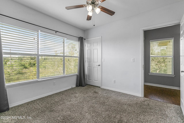 unfurnished room with ceiling fan and carpet flooring