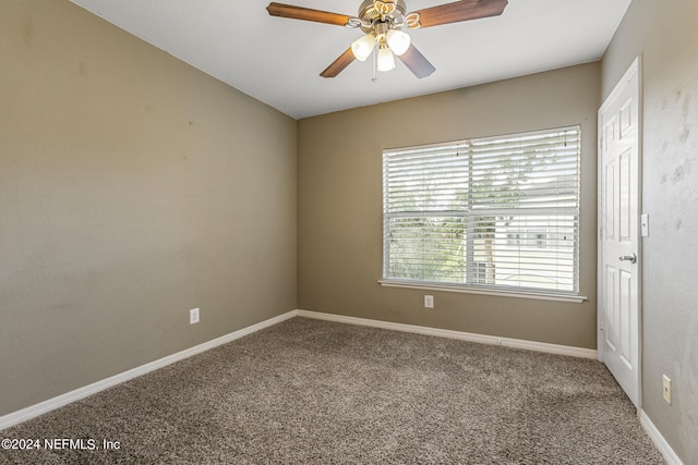 empty room featuring ceiling fan and carpet flooring