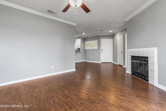 unfurnished living room featuring crown molding, ceiling fan, a fireplace, and dark hardwood / wood-style floors