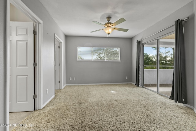 unfurnished room featuring ceiling fan and light colored carpet