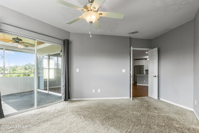 empty room with ceiling fan and carpet flooring