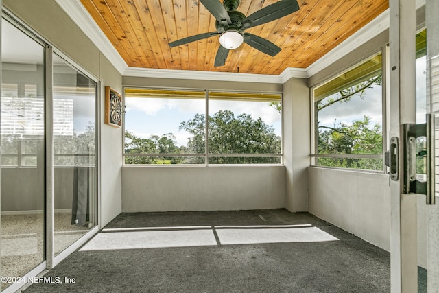 unfurnished sunroom featuring ceiling fan and wood ceiling